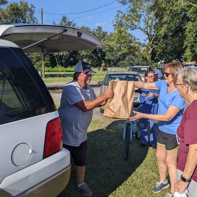 DC Downtown volunteers distributing food to a local family