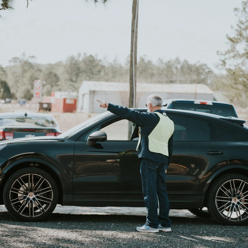 Destination Church volunteer helping direct arriving vehicles